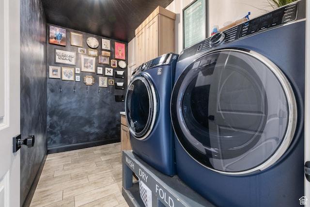 2883 S 3640 W, Hurricane, UT 84737 - washroom featuring washing machine and clothes dryer, light wood-style flooring, baseboards, and cabinet space