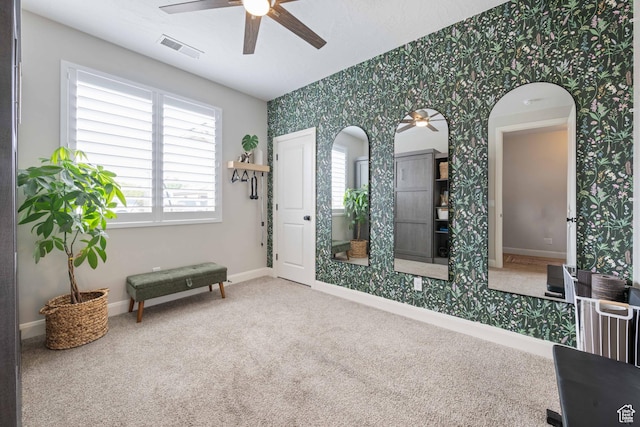 2883 S 3640 W, Hurricane, UT 84737 - living area with wallpapered walls, ceiling fan, carpet floors, baseboards, and arched walkways