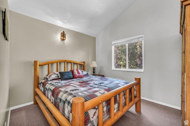 bedroom with carpet floors, lofted ceiling, and baseboards