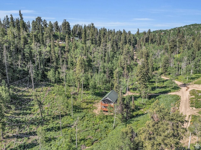 aerial view of property and surrounding area with a forest