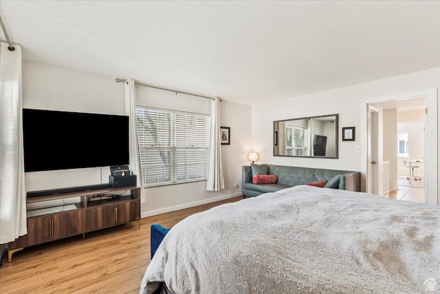 bedroom featuring light wood-type flooring and baseboards