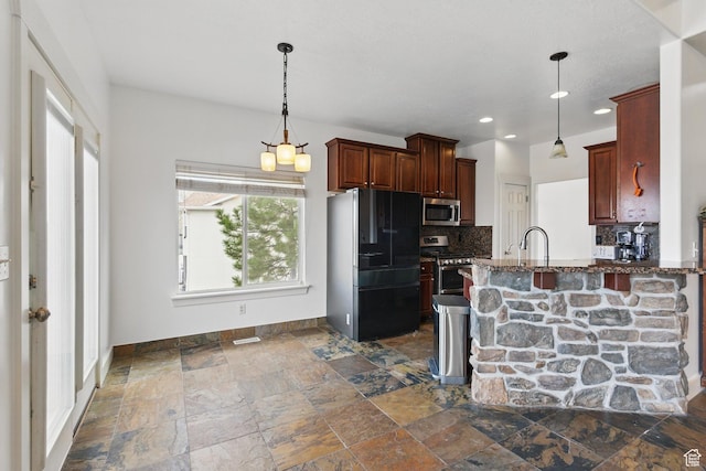 14349 S Round Rock Dr, Herriman, UT 84096 - kitchen with stainless steel appliances, tasteful backsplash, baseboards, dark stone finish flooring, and a peninsula