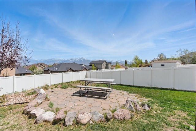 14349 S Round Rock Dr, Herriman, UT 84096 - fenced backyard with a patio, a residential view, and a mountain view