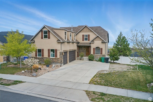 14349 S Round Rock Dr, Herriman, UT 84096 - craftsman-style home with fence, stucco siding, stone siding, concrete driveway, and a garage