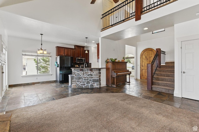 14349 S Round Rock Dr, Herriman, UT 84096 - living area featuring stone tile flooring, baseboards, a ceiling fan, stairway, and recessed lighting