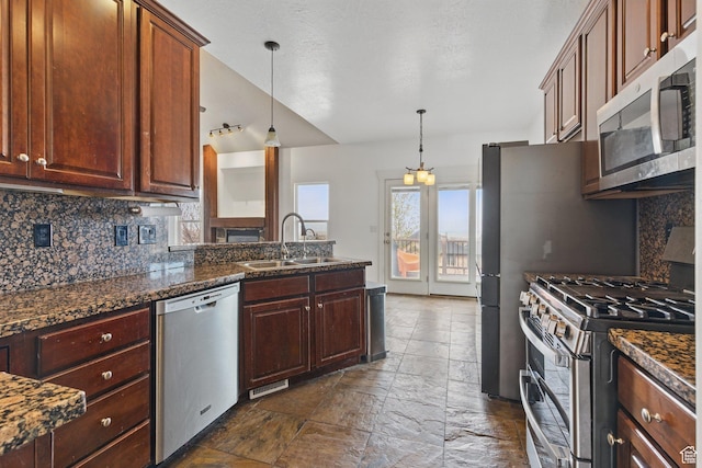 14349 S Round Rock Dr, Herriman, UT 84096 - kitchen with stainless steel appliances, a sink, tasteful backsplash, and hanging light fixtures