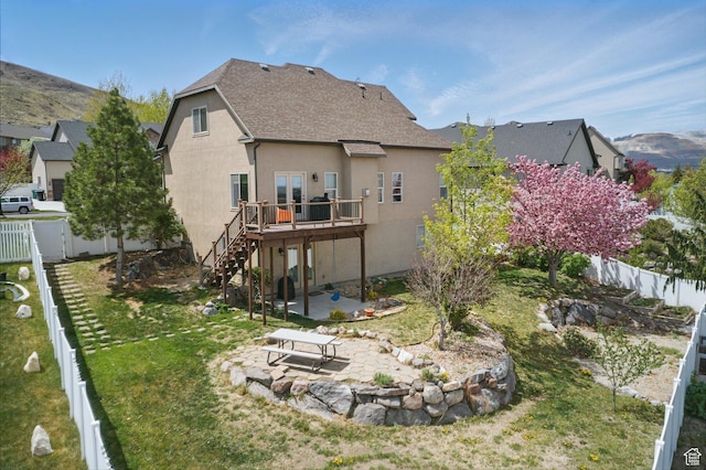 14349 S Round Rock Dr, Herriman, UT 84096 - rear view of house featuring a patio, a wooden deck, a shingled roof, stucco siding, and stairway