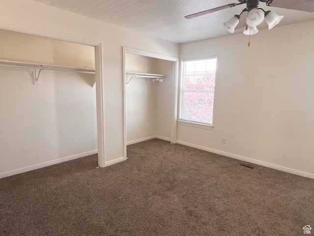 354 E 950 S, Payson, UT 84651 - unfurnished bedroom with two closets, dark carpet, a textured ceiling, ceiling fan, and baseboards