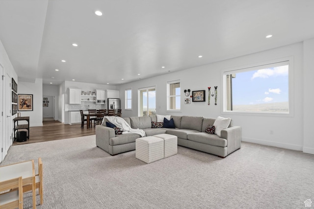 living area featuring recessed lighting, baseboards, and wood finished floors