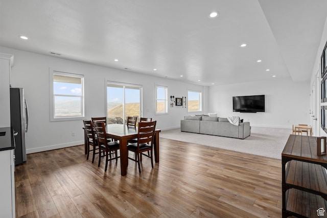 dining room with recessed lighting, baseboards, and wood finished floors