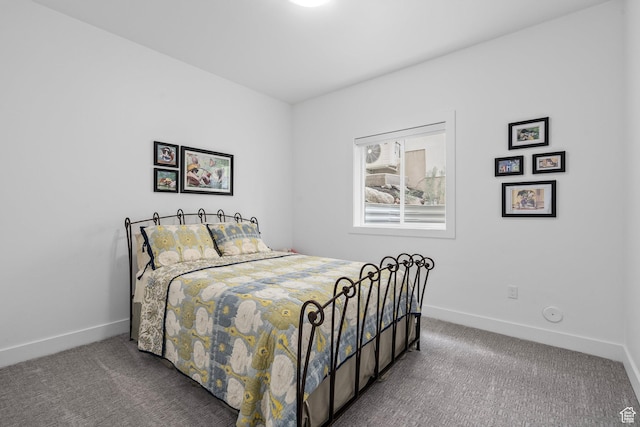 bedroom featuring carpet and baseboards