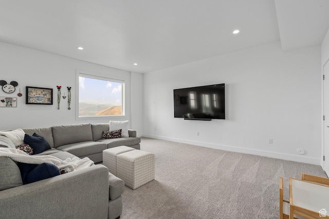 carpeted living area with baseboards and recessed lighting