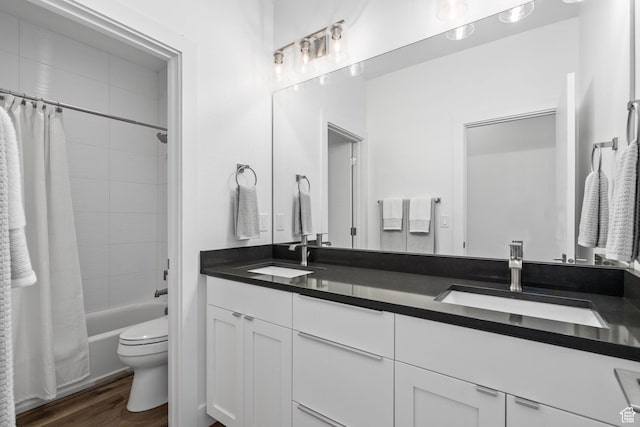 full bath featuring wood finished floors, toilet, double vanity, and shower / bathtub combination with curtain