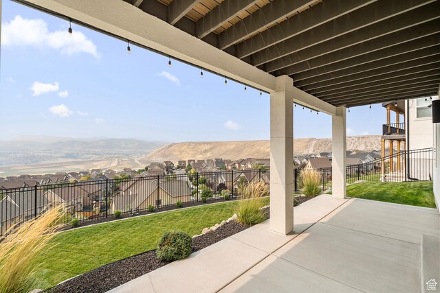 view of patio with a residential view and a mountain view