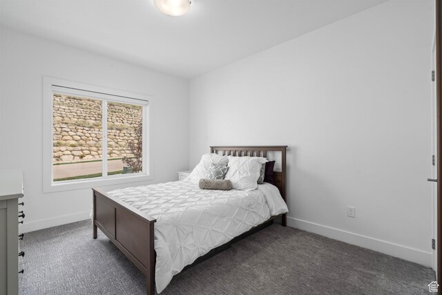 bedroom featuring carpet floors and baseboards