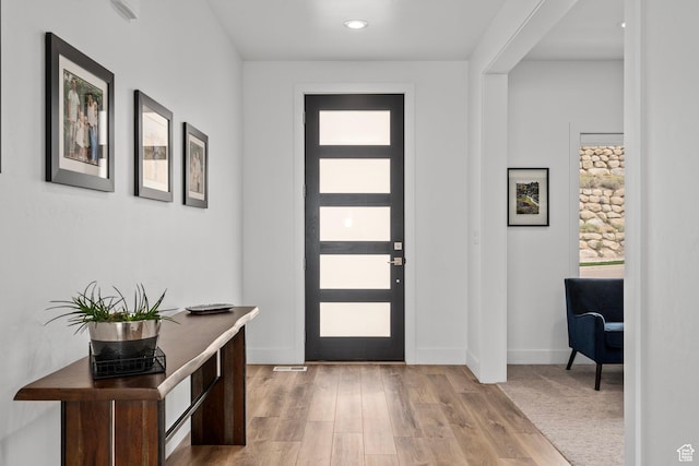 foyer with baseboards, recessed lighting, and light wood-type flooring