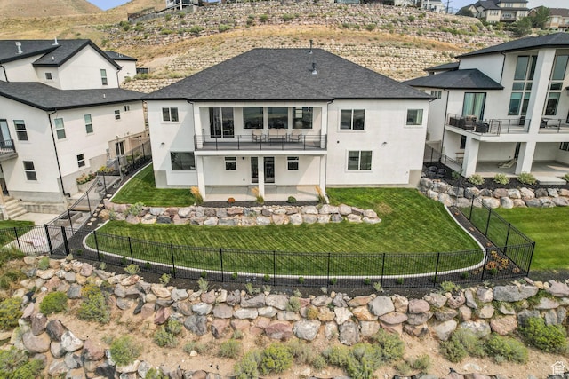 back of house featuring stucco siding, a shingled roof, a mountain view, and a patio
