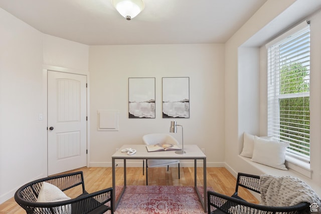office space with baseboards and wood finished floors