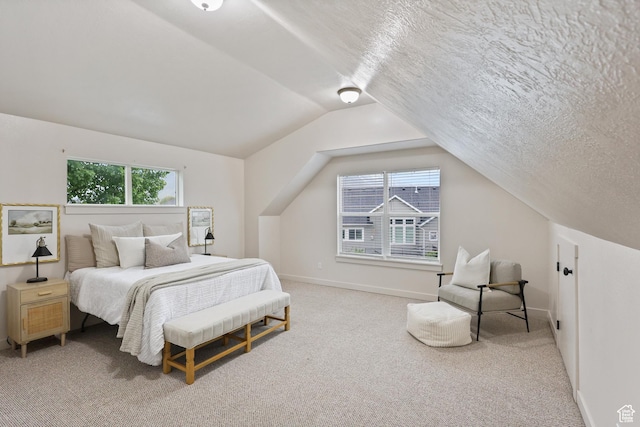 bedroom featuring carpet, lofted ceiling, and baseboards