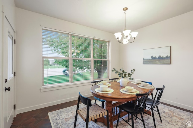 dining space featuring a chandelier, plenty of natural light, and baseboards
