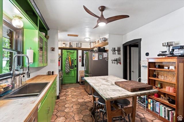 162 E Cleveland, Salt Lake City, UT 84115 - kitchen featuring green cabinets, a sink, freestanding refrigerator, light countertops, and a ceiling fan