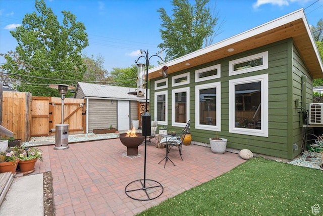 162 E Cleveland, Salt Lake City, UT 84115 - rear view of house with a gate, a patio, an outdoor fire pit, and fence