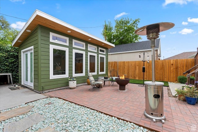 162 E Cleveland, Salt Lake City, UT 84115 - view of patio featuring fence, an outbuilding, and a fire pit