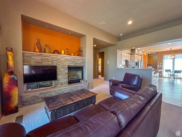 2255 N Tuweap Dr Unit 50, St George, UT 84770 - living area with light colored carpet, recessed lighting, a stone fireplace, and light tile patterned flooring