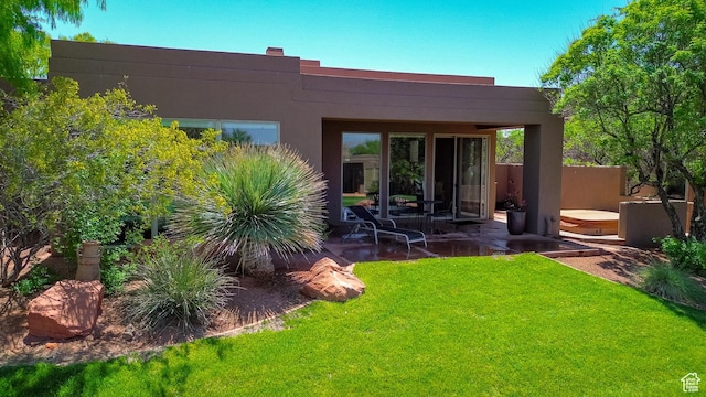 2255 N Tuweap Dr Unit 50, St George, UT 84770 - rear view of house with a yard, stucco siding, and a patio