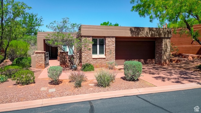 2255 N Tuweap Dr Unit 50, St George, UT 84770 - pueblo revival-style home with a garage, stone siding, driveway, and stucco siding