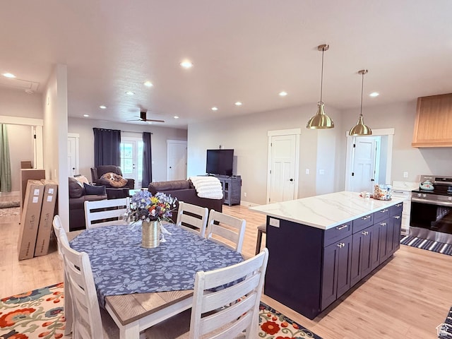 295 E 2nd N, Paris, ID 83261 - kitchen featuring stainless steel electric stove, light wood-type flooring, recessed lighting, a kitchen island, and open floor plan