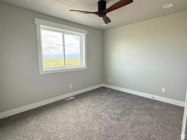 295 E 2nd N, Paris, ID 83261 - spare room featuring a ceiling fan, dark carpet, and baseboards
