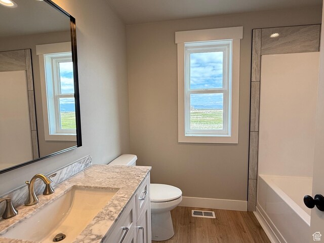 295 E 2nd N, Paris, ID 83261 - bathroom featuring plenty of natural light, baseboards, wood finished floors, toilet, and recessed lighting