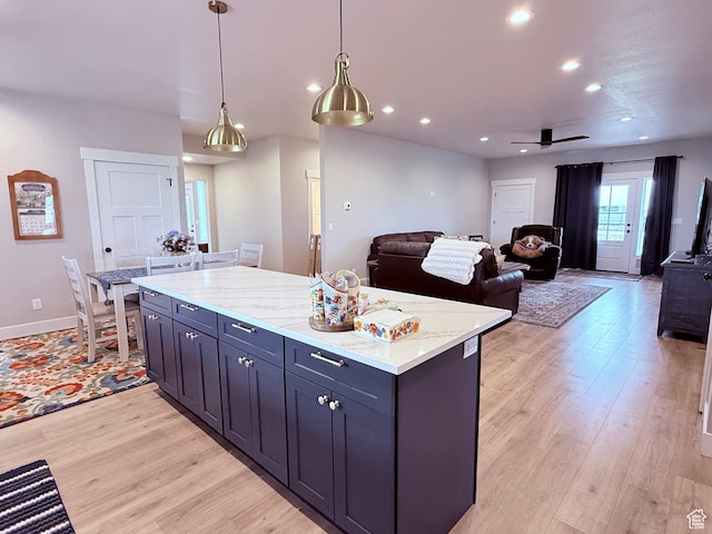 295 E 2nd N, Paris, ID 83261 - kitchen with light wood-style flooring, ceiling fan, recessed lighting, a kitchen island, and decorative light fixtures