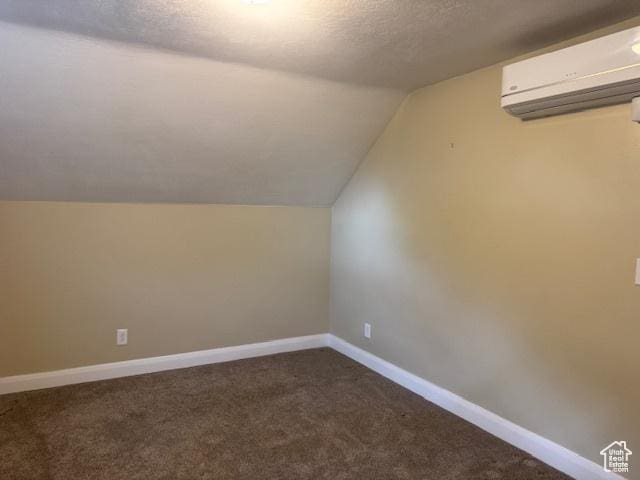 105 S 500 E, Salem, UT 84653 - additional living space with an AC wall unit, lofted ceiling, carpet, a textured ceiling, and baseboards