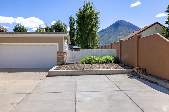 105 S 500 E, Salem, UT 84653 - view of property exterior featuring a mountain view, a garage, and stone siding