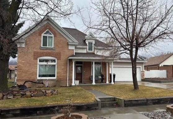 105 S 500 E, Salem, UT 84653 - view of front facade featuring concrete driveway, a front lawn, a garage, and covered porch