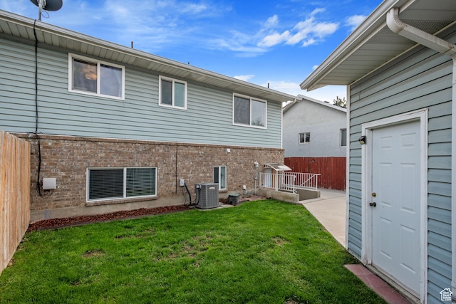 228 W 470 S, American Fork, UT 84003 - rear view of property featuring brick siding, central air condition unit, and a patio