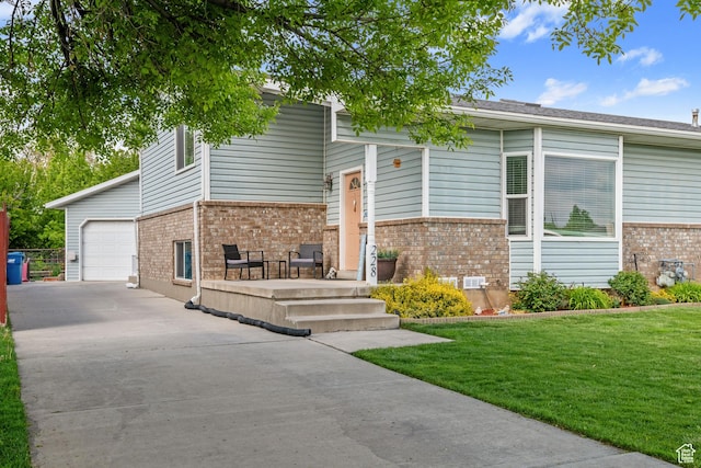 228 W 470 S, American Fork, UT 84003 - split foyer home featuring brick siding, concrete driveway, a front yard, and an attached garage