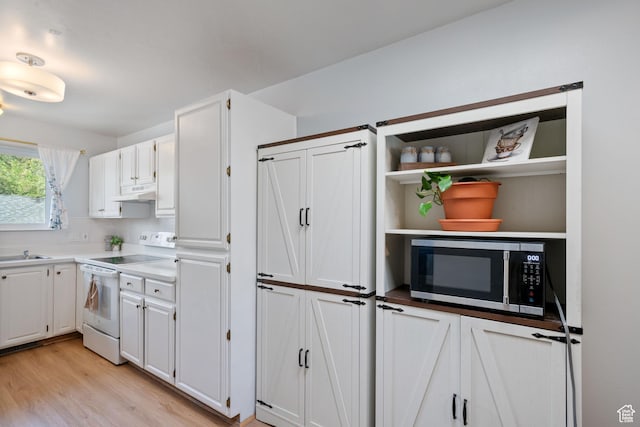 228 W 470 S, American Fork, UT 84003 - kitchen featuring white electric range oven, stainless steel microwave, white cabinets, and light wood-type flooring