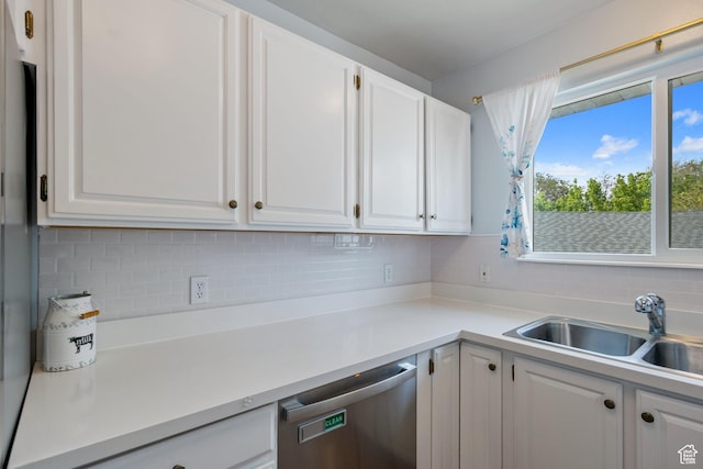 228 W 470 S, American Fork, UT 84003 - kitchen featuring stainless steel dishwasher, a sink, white cabinetry, tasteful backsplash, and light countertops