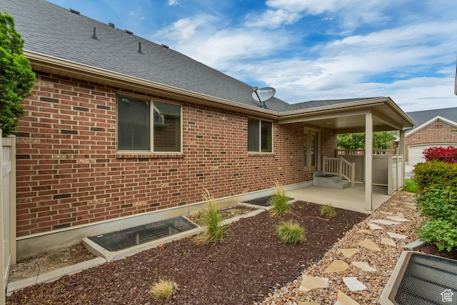 161 S 980 E, American Fork, UT 84003 - rear view of house featuring brick siding, a patio, and a shingled roof