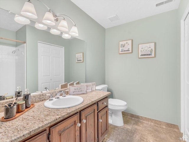 bathroom with toilet, vanity, a chandelier, a shower, and baseboards