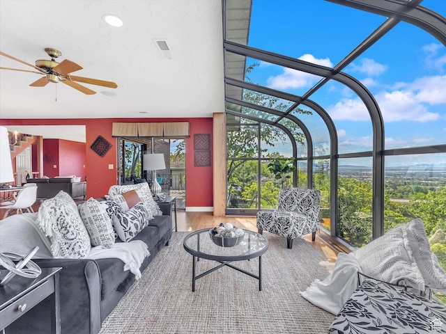 living room featuring a sunroom, a ceiling fan, wood finished floors, and recessed lighting