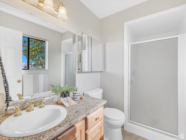 full bathroom with a stall shower, toilet, vanity, and tile patterned flooring