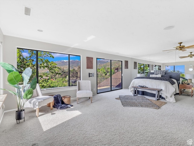 carpeted bedroom with access to outside, a ceiling fan, and baseboards