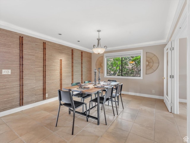 dining space featuring baseboards, light tile patterned flooring, and crown molding
