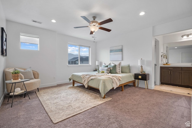 bedroom featuring light colored carpet, recessed lighting, ceiling fan, baseboards, and connected bathroom