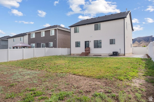 rear view of property featuring cooling unit, a patio, and stucco siding