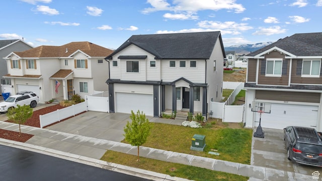 view of front of house with an attached garage, a gate, concrete driveway, and a residential view